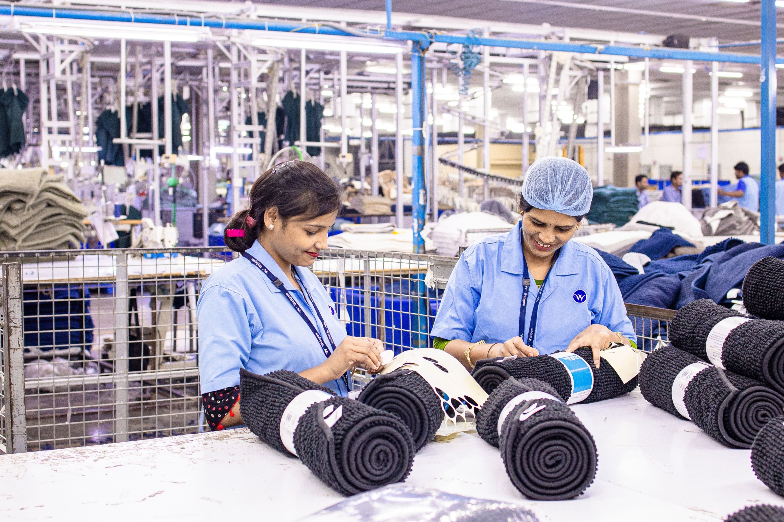 Women working in an Ethiopian textile factory, rolling colorful fabrics. Ethiopia's Textile Industry