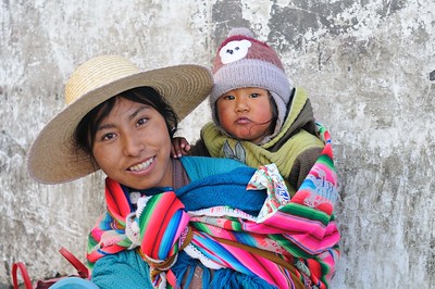 A Bolivian Indigenous leader speaking at a political gathering, highlighting Indigenous political representation. Poverty in Bolivia