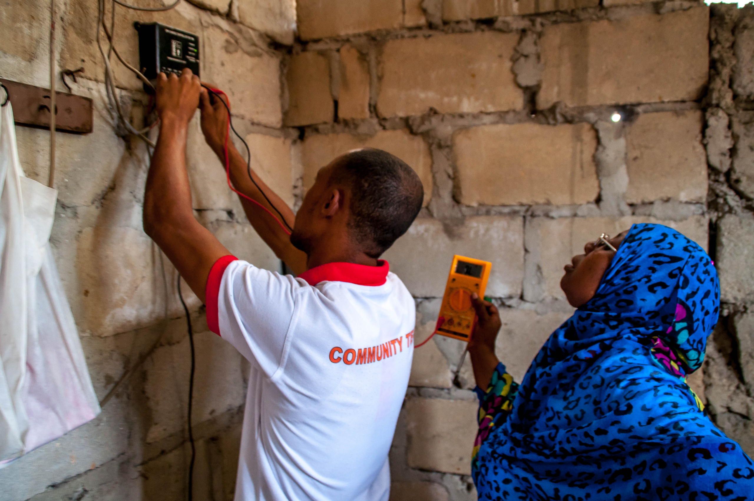Women assembling solar panels, showcasing Solar Mamas empowerment in Zanzibar. Poverty in Zanzibar