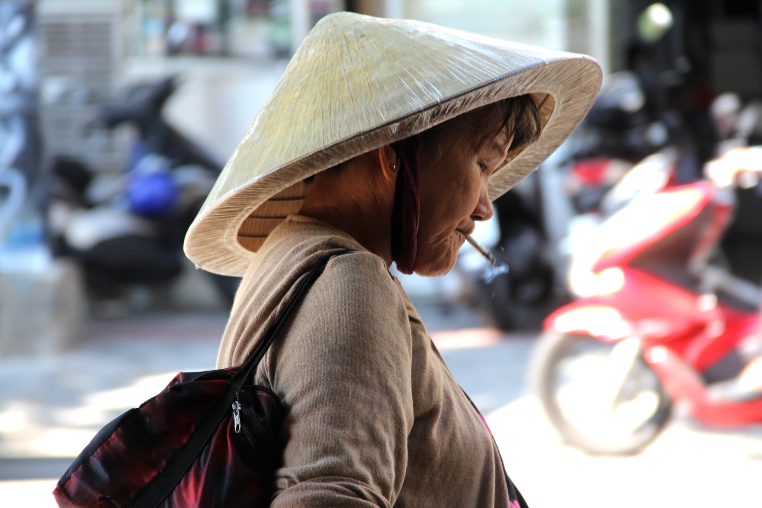 Woman carrying water buckets, walking through a rural area. Water Kiosks in Cambodia
